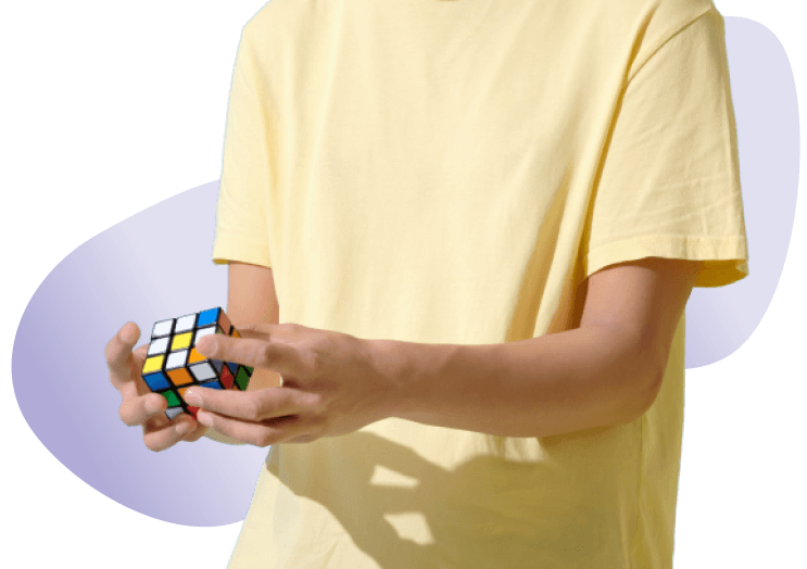 A men solving rubik cube puzzle